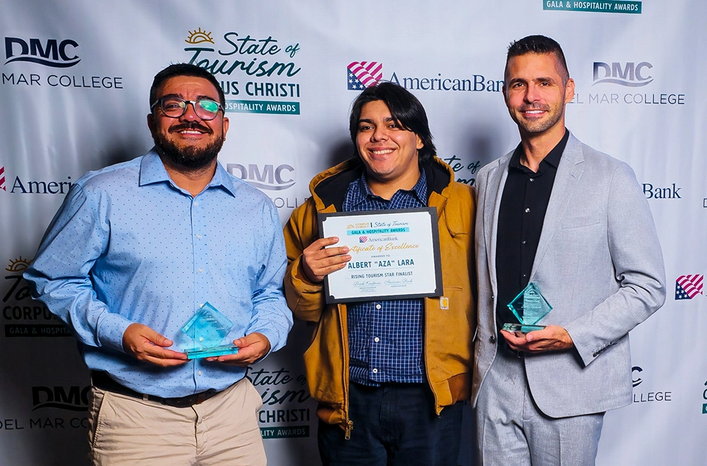 3 guys standing on a red carpet